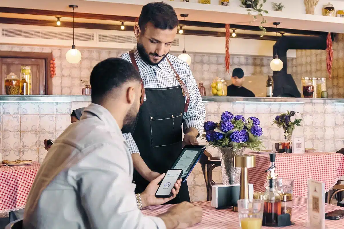 Restaurant staff using waiter app for efficient Suhur service during pre-dawn hours